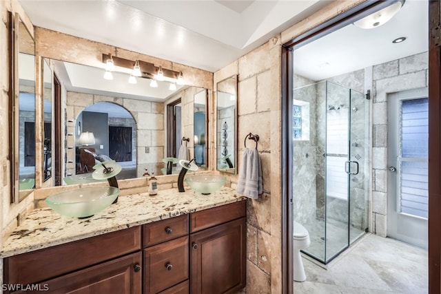 bathroom with toilet, vanity, and walk in shower