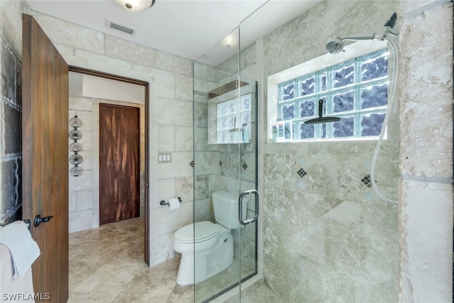 bathroom featuring toilet, tile walls, and walk in shower