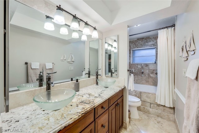 full bathroom with shower / bath combo with shower curtain, vanity, and toilet