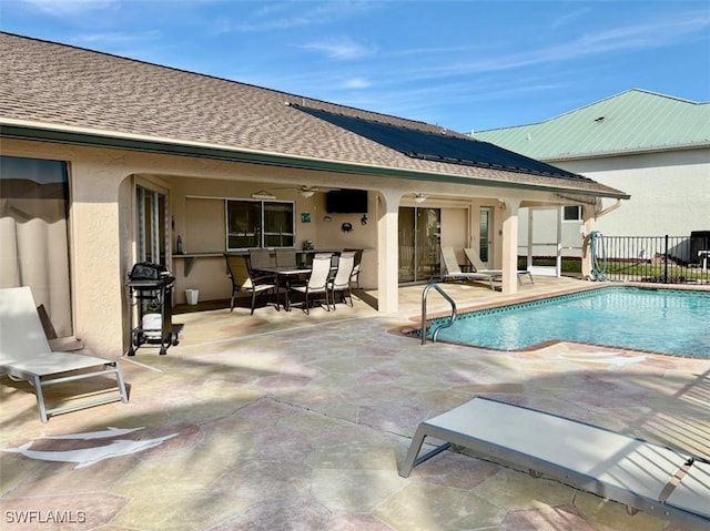 view of swimming pool featuring ceiling fan and a patio