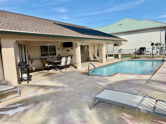 view of swimming pool with a patio, area for grilling, and ceiling fan