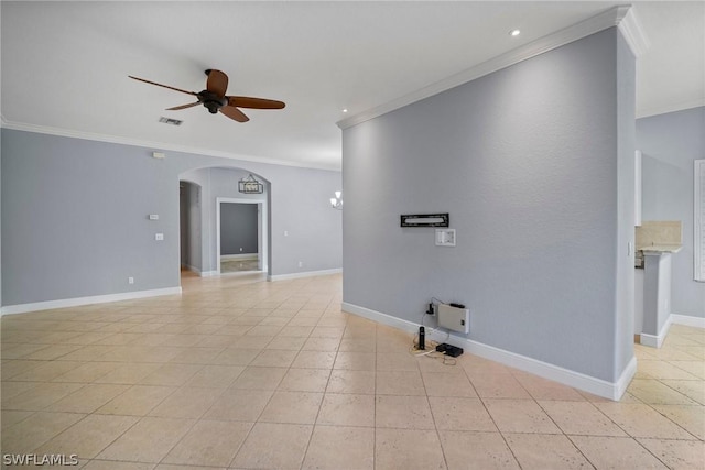 spare room featuring arched walkways, ceiling fan, visible vents, and baseboards