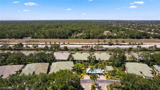 drone / aerial view with a forest view and a residential view