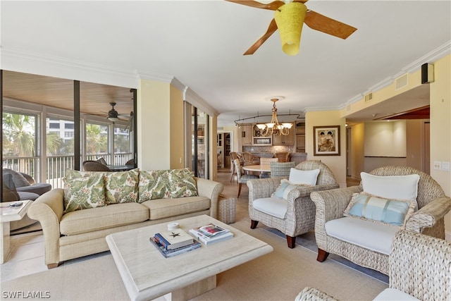 living room featuring ceiling fan with notable chandelier, light colored carpet, and crown molding