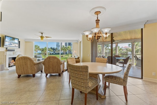 tiled dining room featuring crown molding and ceiling fan with notable chandelier