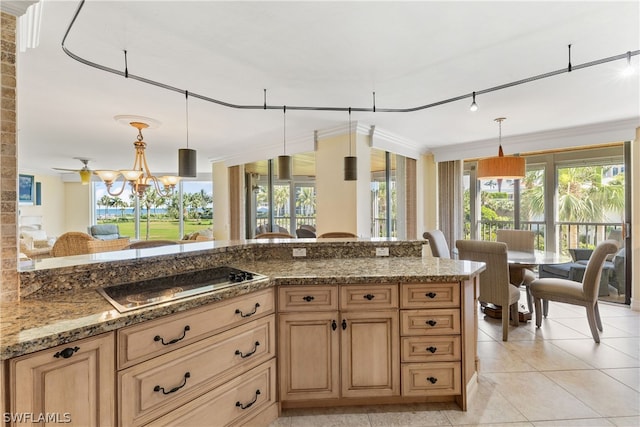 kitchen with stone counters, a notable chandelier, stovetop, decorative light fixtures, and light tile patterned floors