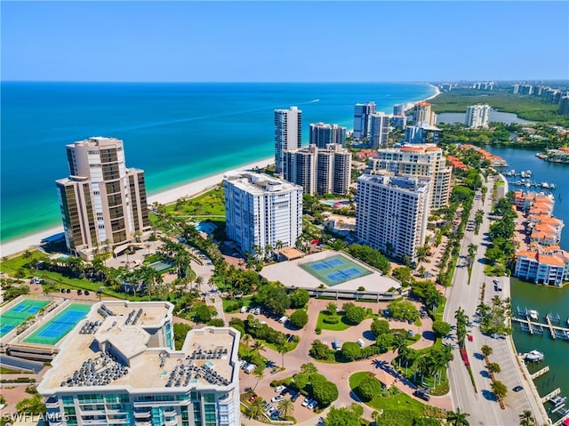 drone / aerial view featuring a beach view and a water view