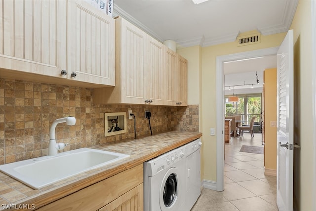 laundry area with sink, cabinets, crown molding, and washer / clothes dryer