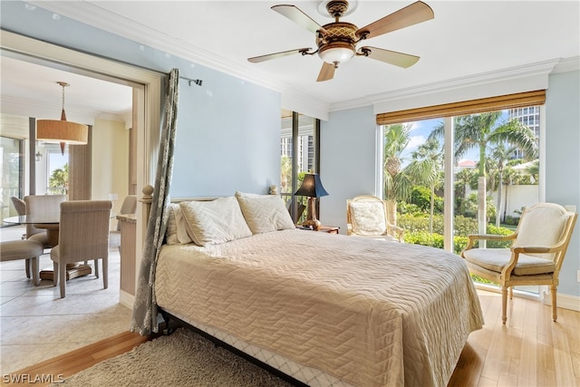 bedroom featuring multiple windows, ceiling fan, and light hardwood / wood-style floors