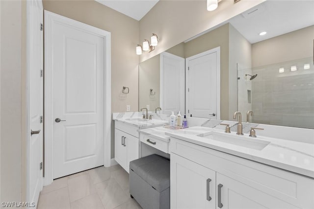 bathroom with tile patterned flooring, vanity, and an enclosed shower