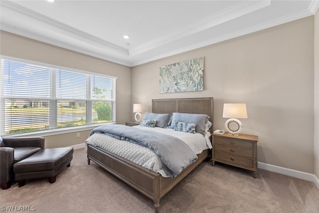 bedroom with a raised ceiling, light colored carpet, and ornamental molding