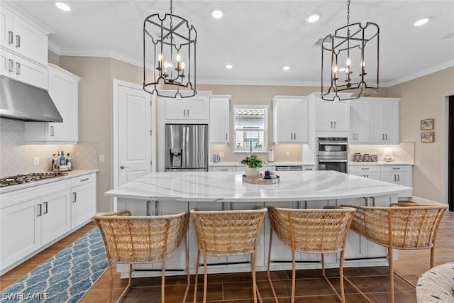 kitchen with pendant lighting, a spacious island, stainless steel appliances, and an inviting chandelier