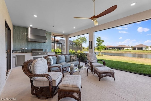 sunroom with a water view and ceiling fan