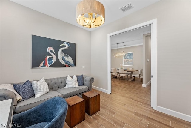 living room featuring wood-type flooring and a notable chandelier