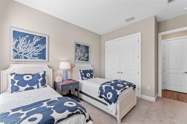 carpeted bedroom with a closet