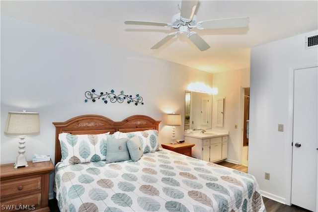 bedroom featuring connected bathroom, ceiling fan, sink, and wood-type flooring