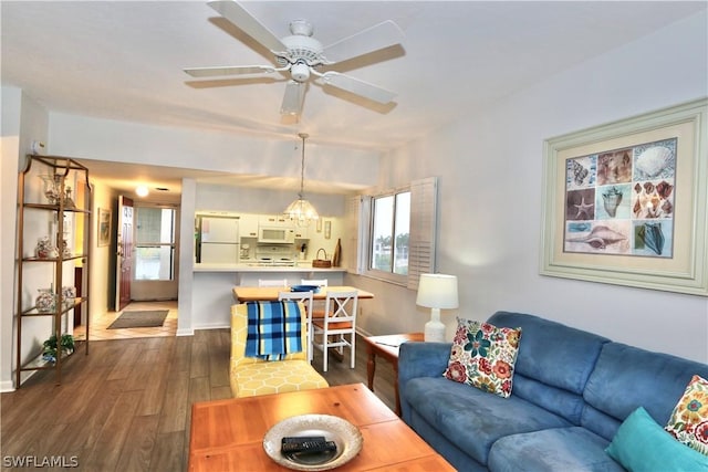 living room featuring dark hardwood / wood-style flooring and ceiling fan