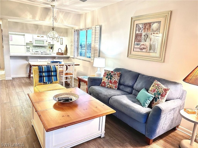 living room featuring hardwood / wood-style floors and an inviting chandelier