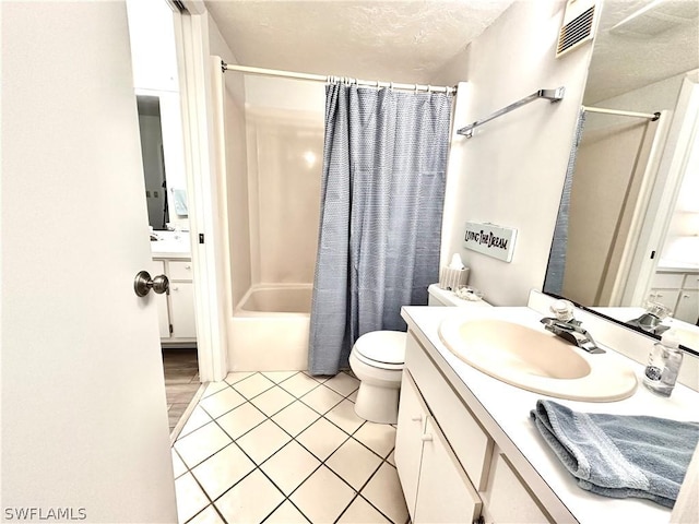 full bathroom with tile patterned flooring, vanity, toilet, and shower / bath combo with shower curtain