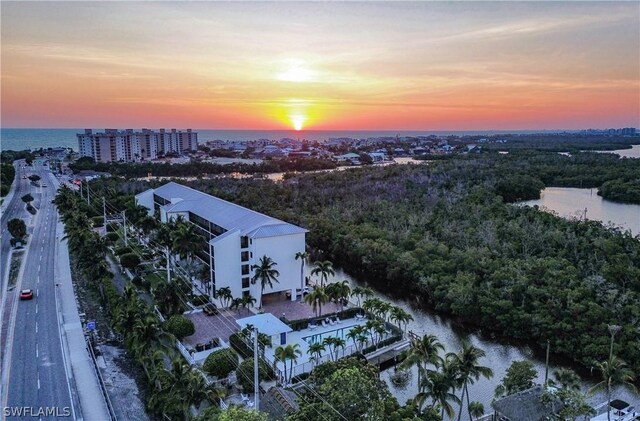 aerial view at dusk with a water view