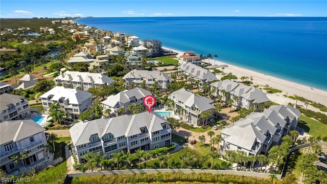 bird's eye view featuring a water view and a beach view