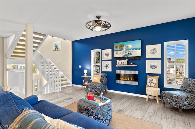 living room with hardwood / wood-style flooring and ceiling fan