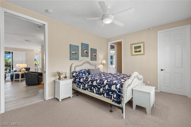 bedroom featuring ceiling fan and light carpet