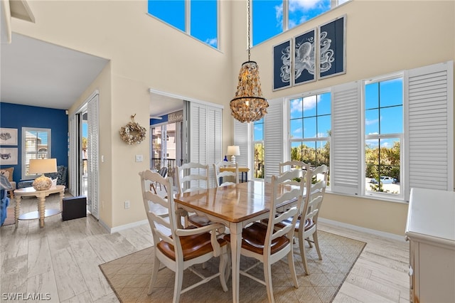 dining area with a chandelier and light hardwood / wood-style flooring