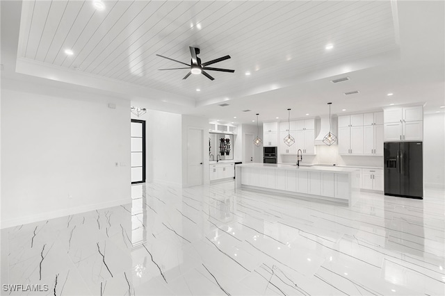 kitchen featuring wooden ceiling, black appliances, a spacious island, and a raised ceiling