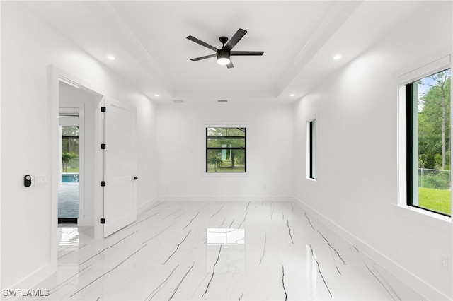 unfurnished room featuring crown molding, a tray ceiling, and ceiling fan