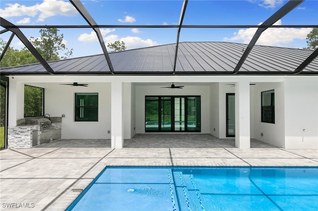 back of house featuring a lanai, exterior kitchen, and ceiling fan