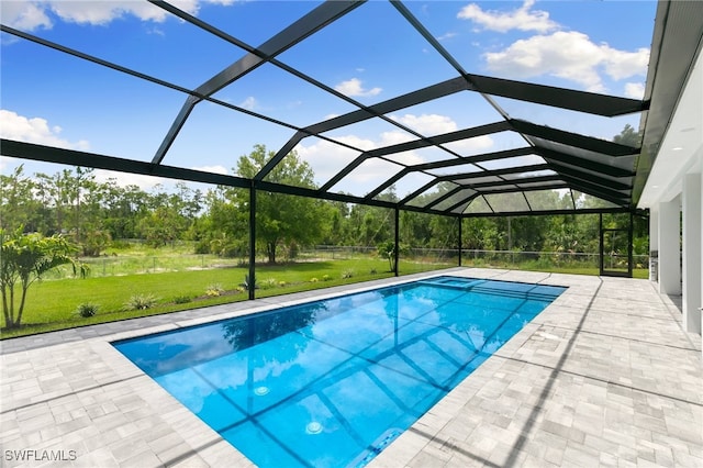 view of swimming pool with a yard, a patio area, and glass enclosure