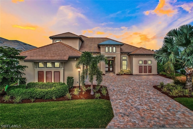 view of front of house featuring a lawn and french doors