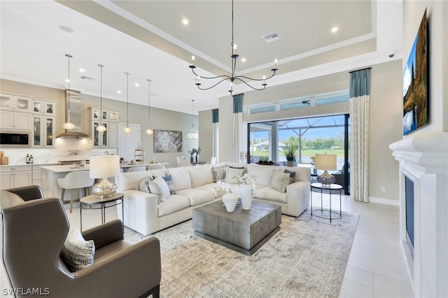 tiled living room featuring an inviting chandelier and ornamental molding