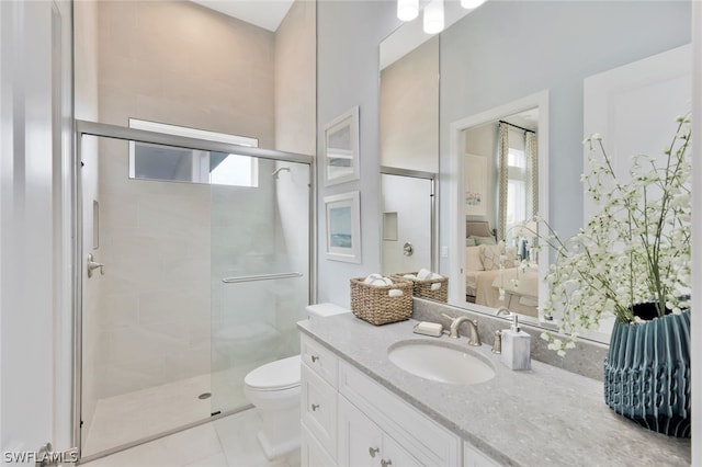 bathroom featuring tile patterned flooring, vanity, toilet, and a shower with door