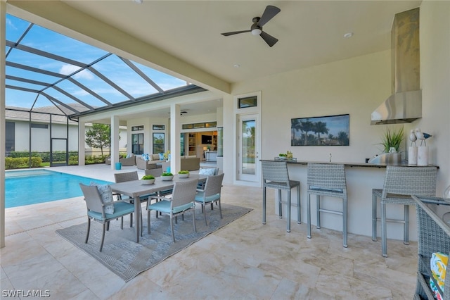 view of patio with exterior bar, an outdoor hangout area, ceiling fan, and a lanai