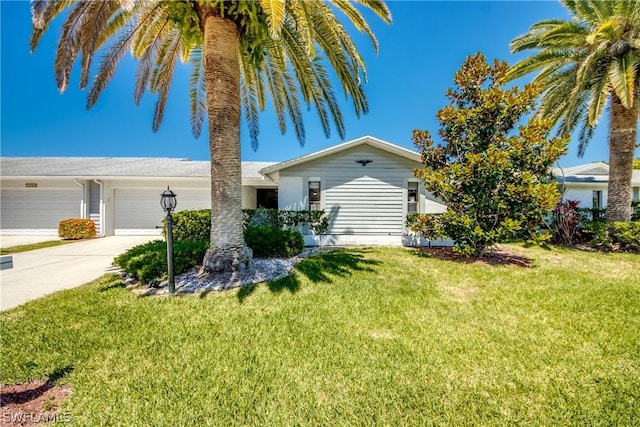 single story home with a garage and a front lawn