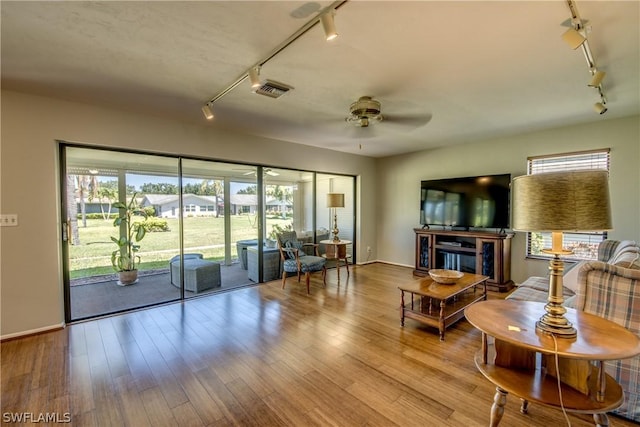 unfurnished living room with track lighting, light hardwood / wood-style flooring, and ceiling fan