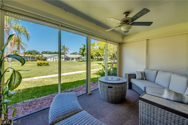 sunroom / solarium featuring ceiling fan