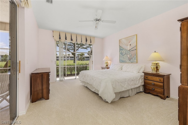 carpeted bedroom featuring access to exterior and ceiling fan