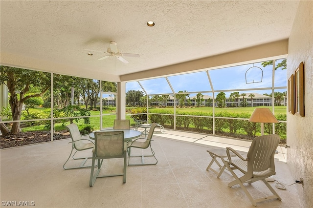 sunroom / solarium featuring ceiling fan