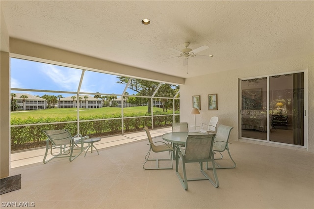 sunroom featuring ceiling fan