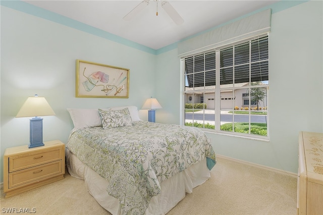 bedroom with light colored carpet and ceiling fan