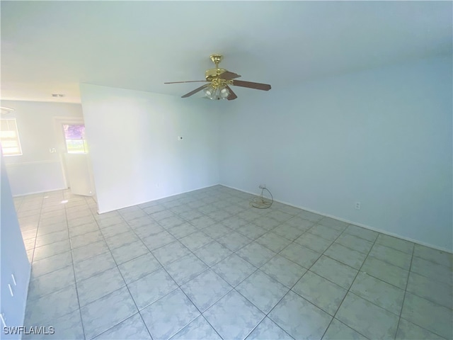 empty room featuring ceiling fan and light tile patterned flooring