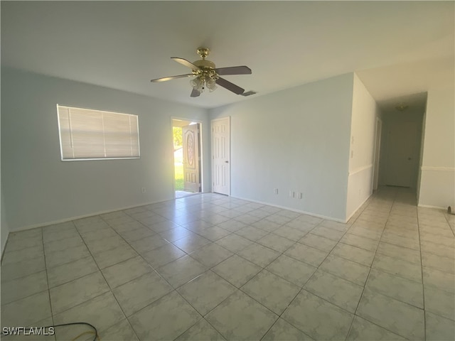 unfurnished room featuring ceiling fan and light tile patterned floors