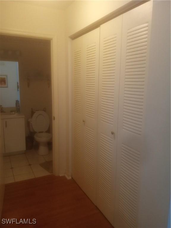 hallway with light tile patterned flooring and sink