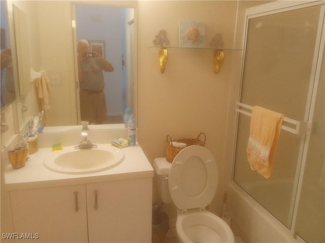 full bathroom with vanity, toilet, and bath / shower combo with glass door