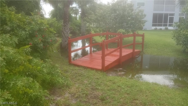 exterior space featuring a lawn and a water view