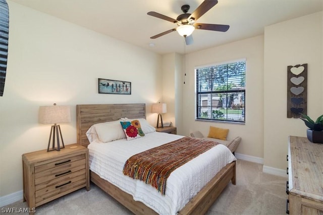 bedroom with baseboards, ceiling fan, and light colored carpet