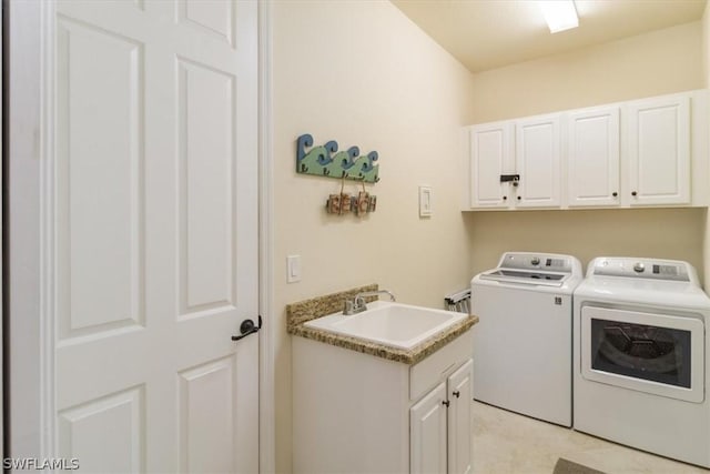 washroom featuring washer and dryer, light tile patterned floors, a sink, and cabinet space